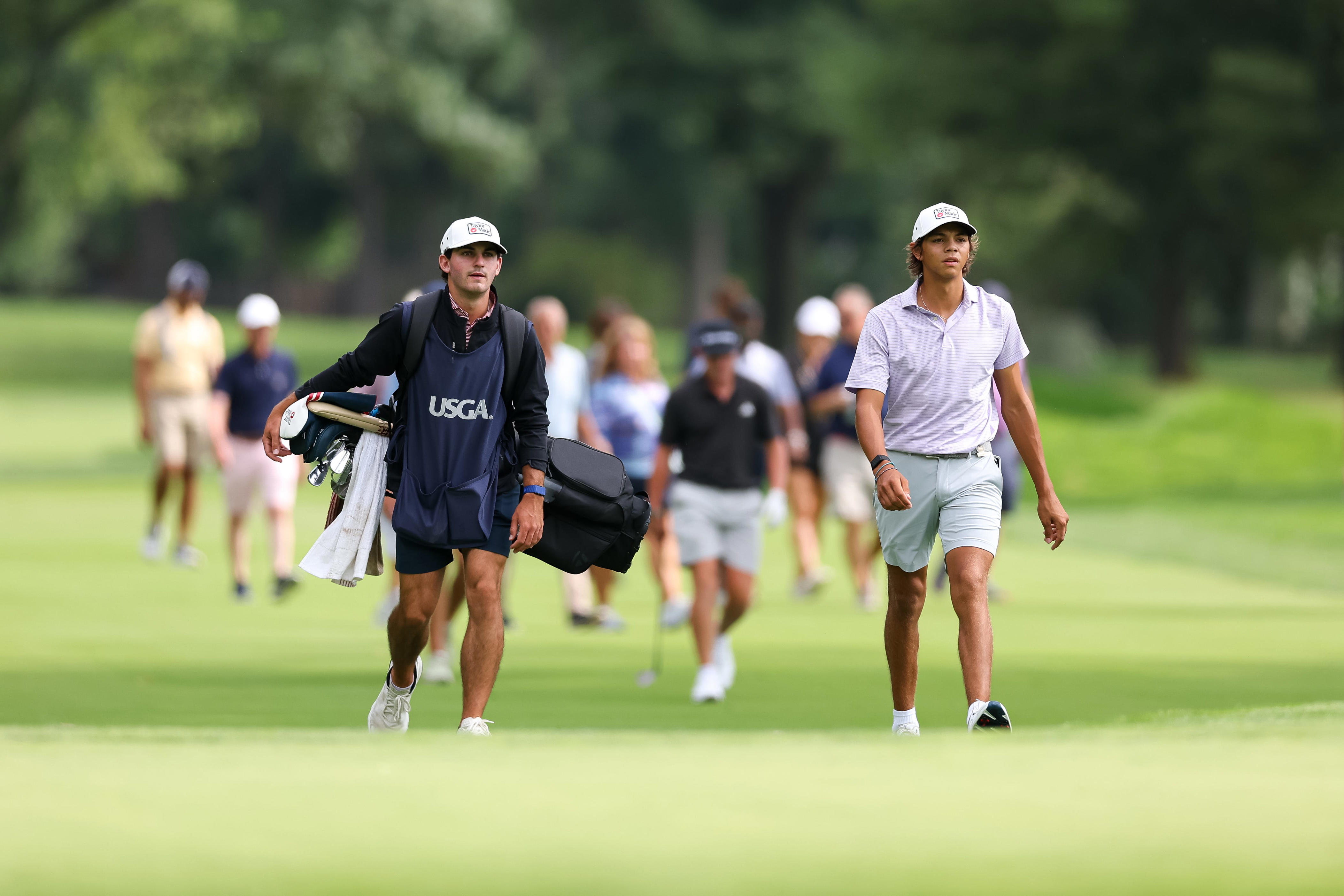 Charlie Woods walks up the 16th hole green with his caddie during the second round of stroke play of the 2026 U.S. Junior Amateur at Saucon Valley C.C. (Old Course) in Bethlehem, Pa. on Tuesday, July 21, 2026.