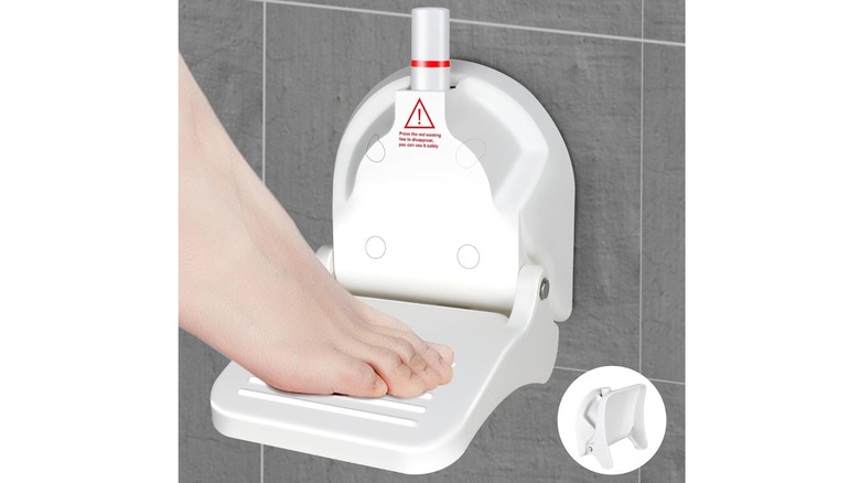 Foot resting on a footrest in a shower