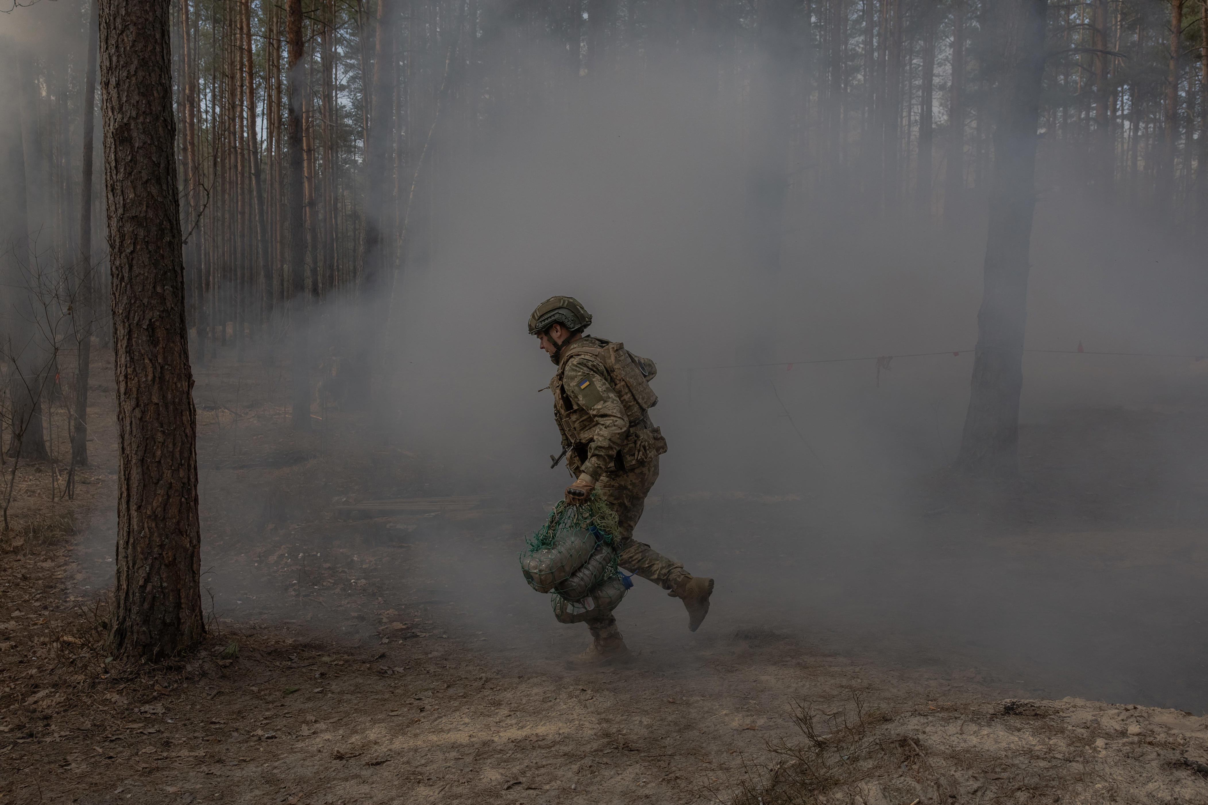 A Ukrainian recruit runs as he completes a basic military training at the Ukrainian Ground Forces training center in an undisclosed location on March 25, 2026, amid the Russian invasion of Ukraine.