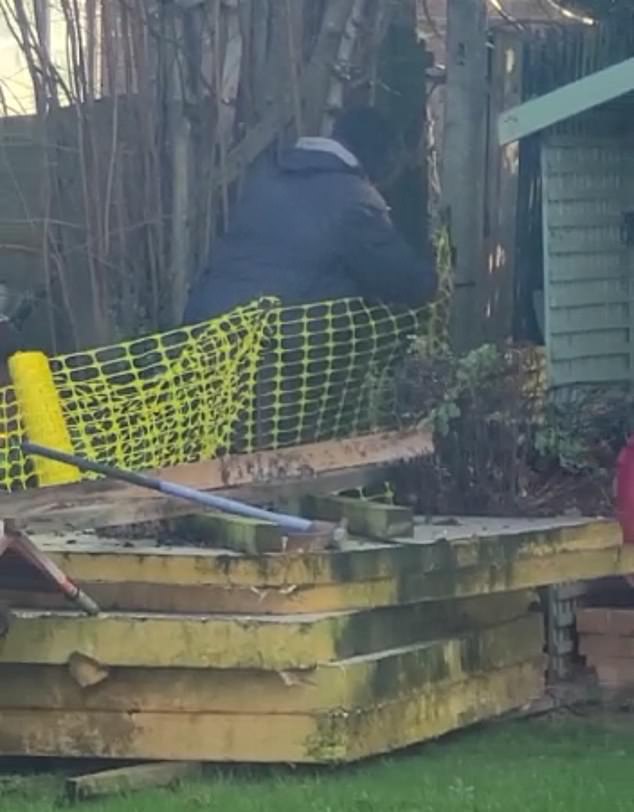 The neighbouring family later erected a makeshift yellow plastic fence after destroying the existing fence and tree boundary