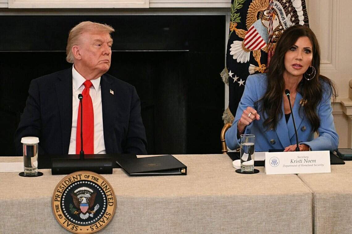 President Donald Trump listens to then-Homeland Security Secretary Kristi Noem at the White House in Washington, D.C., on October 8, 2025. They are accused of showing racial bias in the decision to end TPS for Haitians.