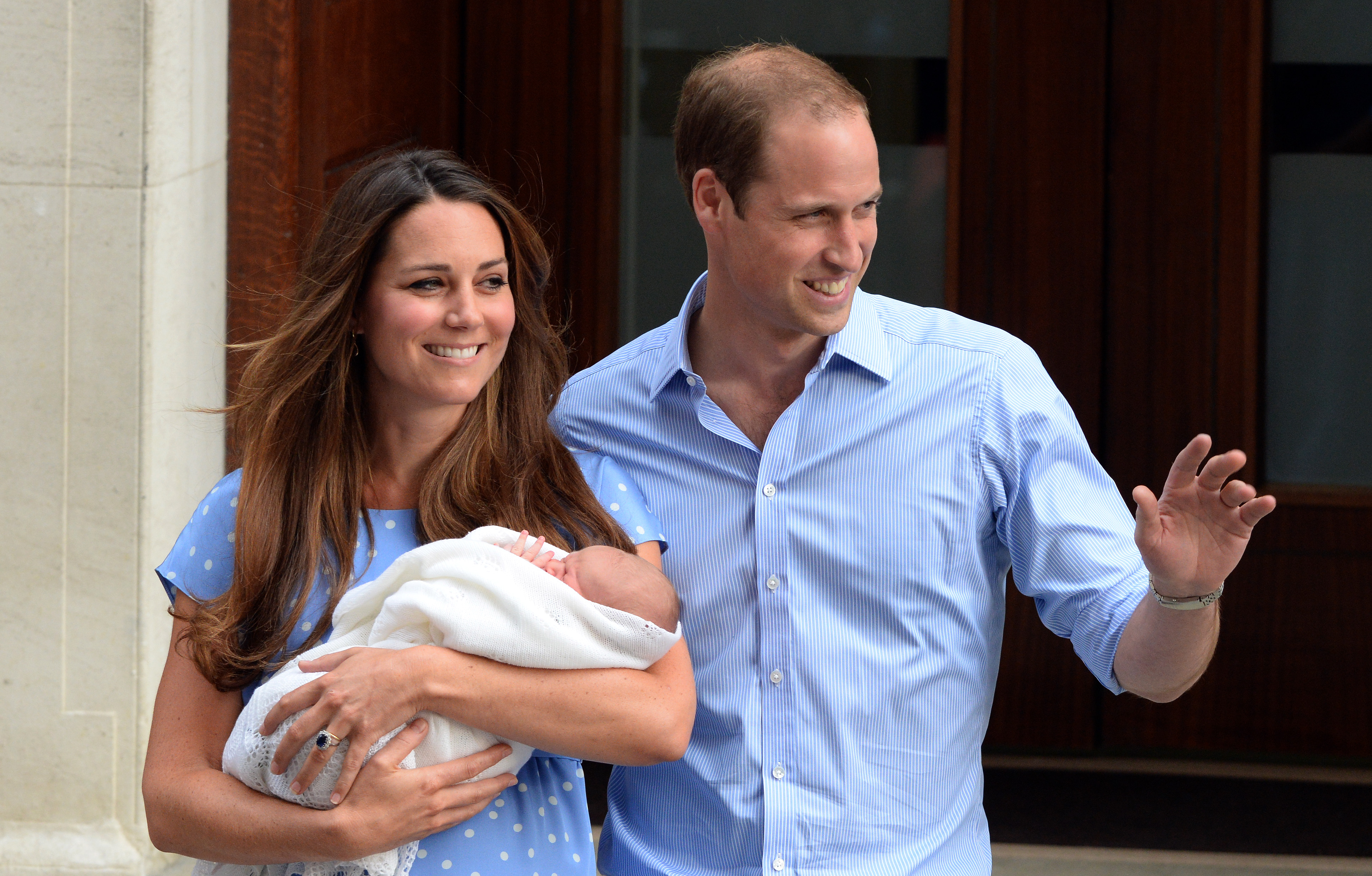 Kate, William and George pose for photographs outside the hospital where George was born in July 2026.