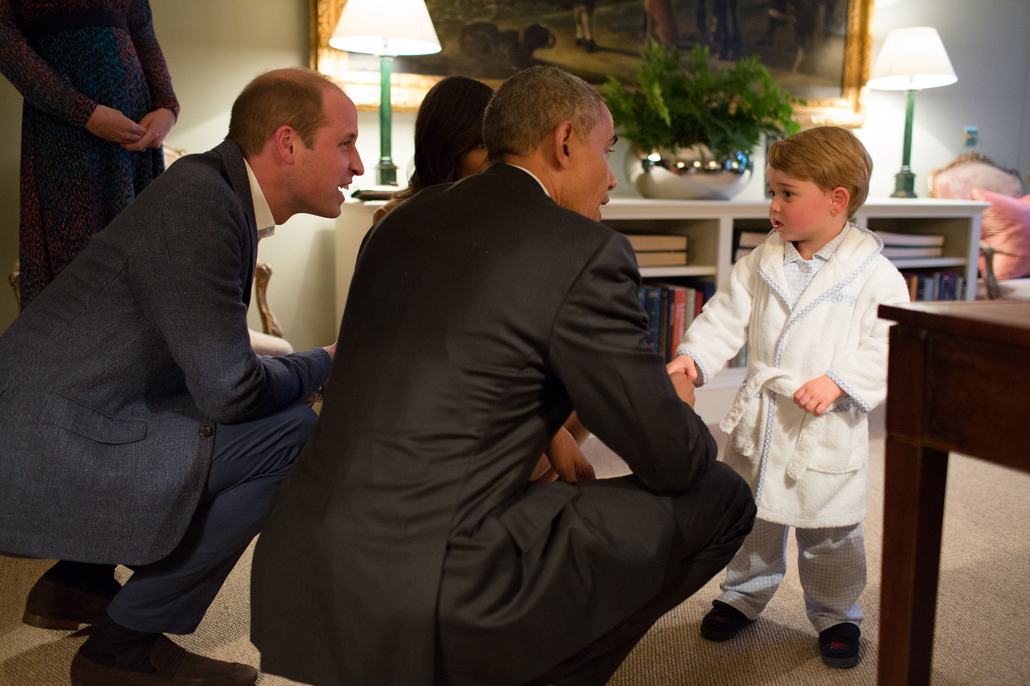 In this handout provided by The White House, President Barack Obama, Prince William, Duke of Cambridge and First Lady Michelle Obama talks with Prince George at Kensington Palace on April 22, 2016 in London, England. The President and his wife are currently on a brief visit to the UK where they attended lunch with HM Queen Elizabeth II at Windsor Castle and later dinner with Prince William and his wife Catherine, Duchess of Cambridge at Kensington Palace. Mr Obama visited 10 Downing Street this afternoon and held a joint press conference with British Prime Minister David Cameron where he stated his case for the UK to remain inside the European Union.