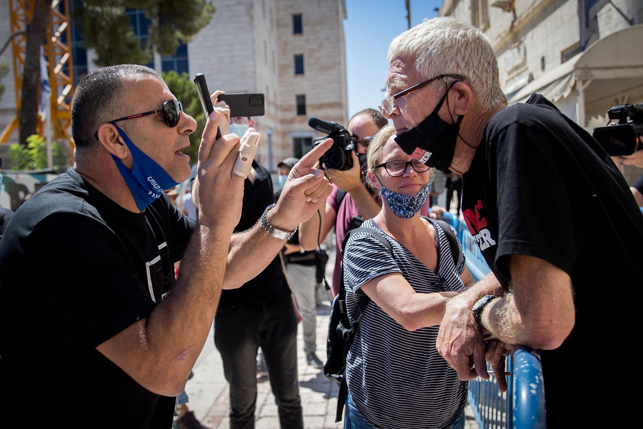 Supporters of Prime Minister Benjamin Netanyahu argue with 