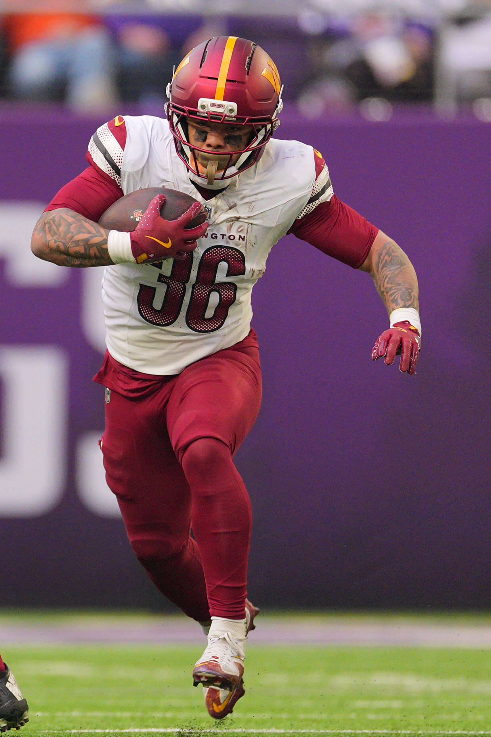 Dec 7, 2025; Minneapolis, Minnesota, USA; Washington Commanders running back Chris Rodriguez Jr. (36) rushes the ball against the Minnesota Vikings during the second half at U.S. Bank Stadium. Mandatory Credit: Brad Rempel-Imagn Images