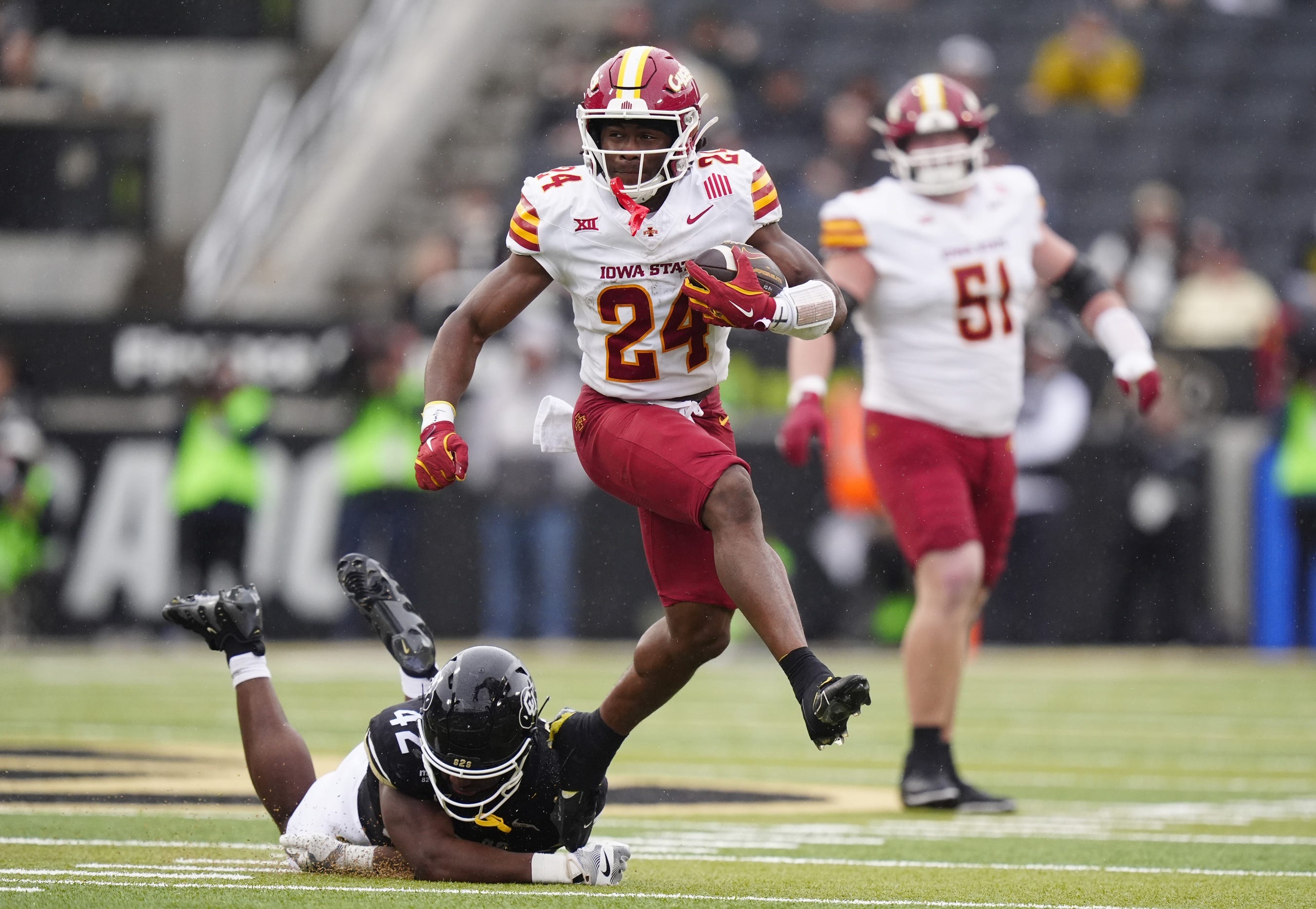 Oct 11, 2025; Boulder, Colorado, USA; Iowa State Cyclones running back Abu Sama (24) is runs past the tackle of Colorado Buffaloes linebacker Jeremiah Brown (42) in the second quarter at Folsom Field. Mandatory Credit: Ron Chenoy-Imagn Images