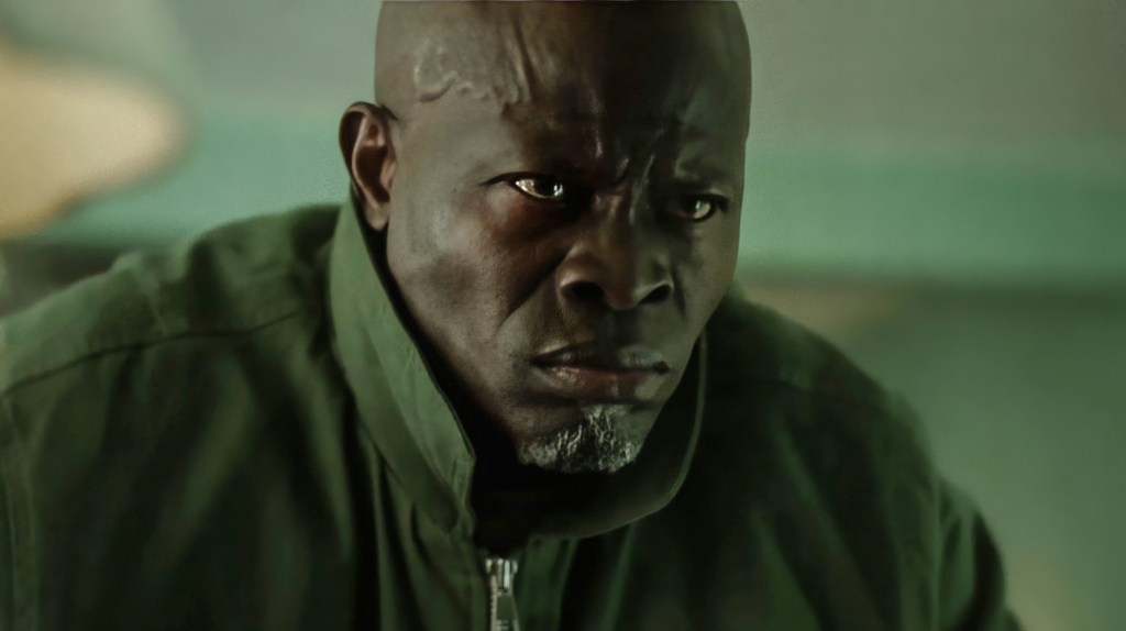 Djimon Hounsou in a close-up, looking concerned.