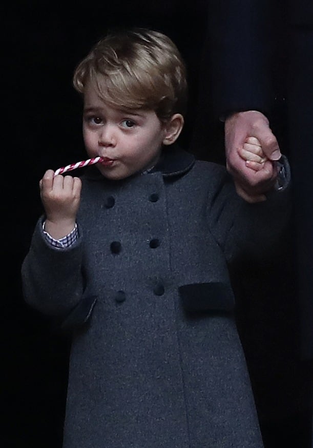 2016: Prince George of Cambridge eats a sweet as he leave following the service at St Mark's Church on Christmas Day on December 25, 2016, in Bucklebury, Berkshire.