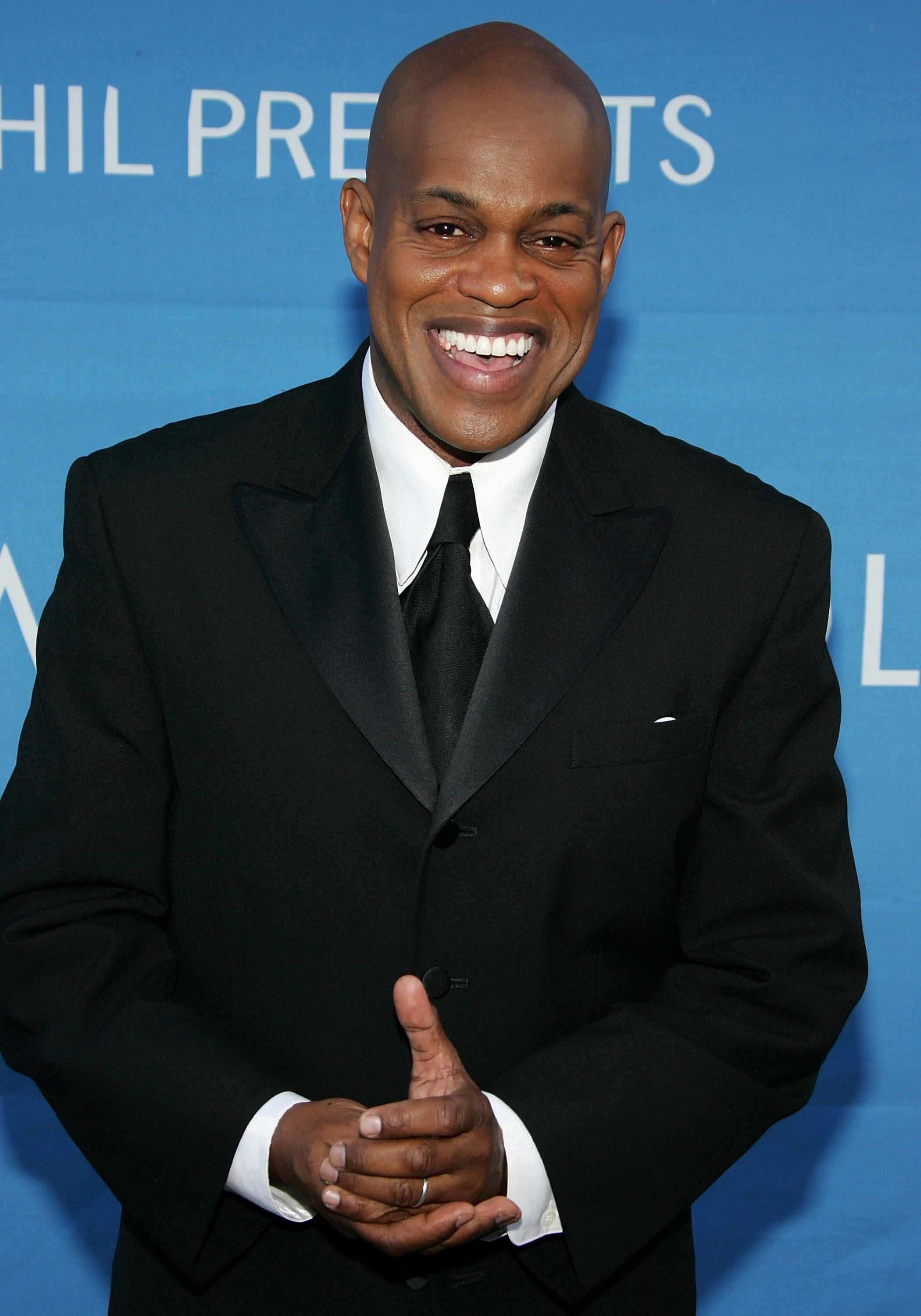 Jubilant Sykes smiling while wearing a tuxedo.