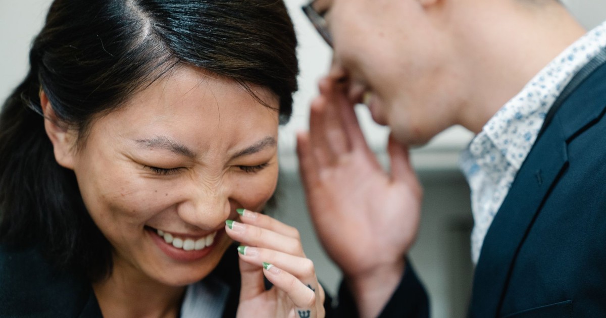 Close-up of a joyful interaction with laughter and whispering.