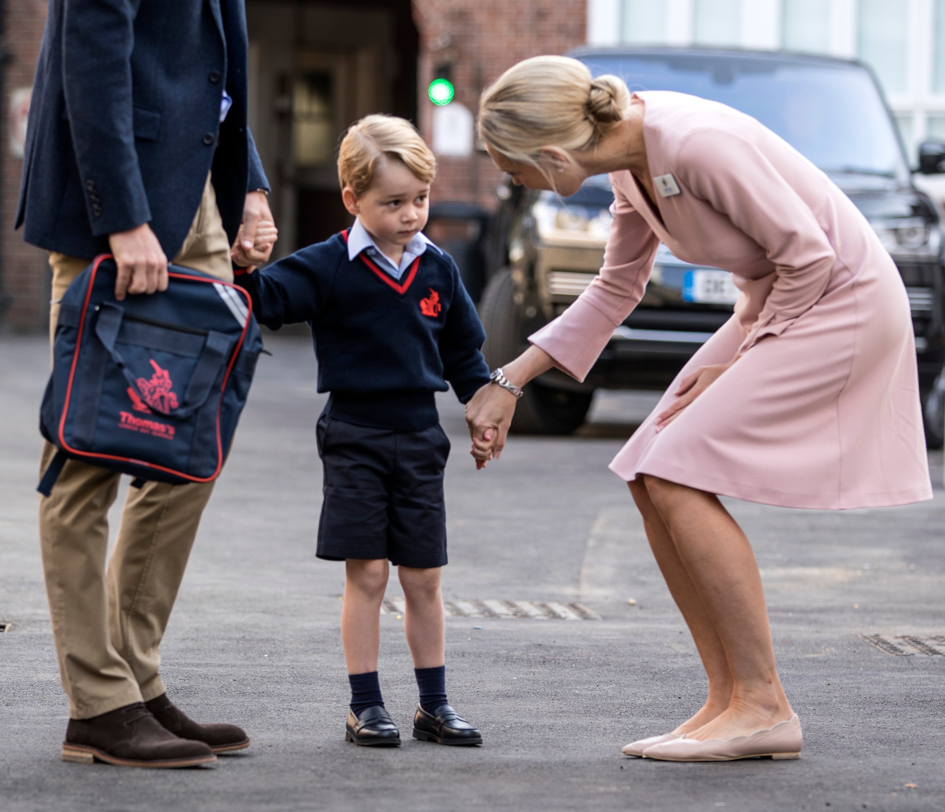 2017: Prince George of Cambridge arrives for his first day of school with his father Prince William, Duke of Cambridge, as they are met Head of the lower school Helen Haslem at Thomas's Battersea on September 7, 2017, in London, England.