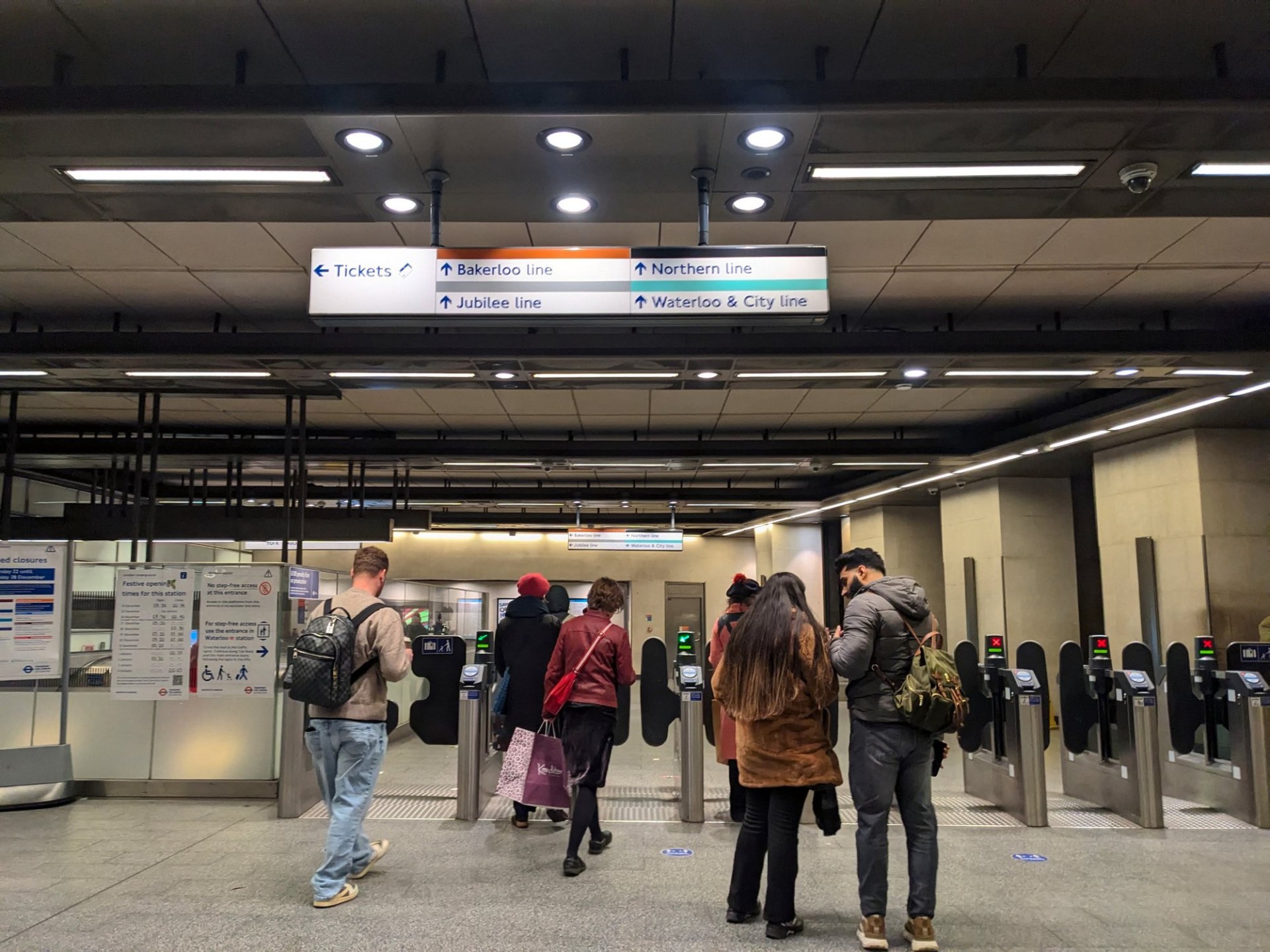 Passengers make their way through the ticket barrier on the underground