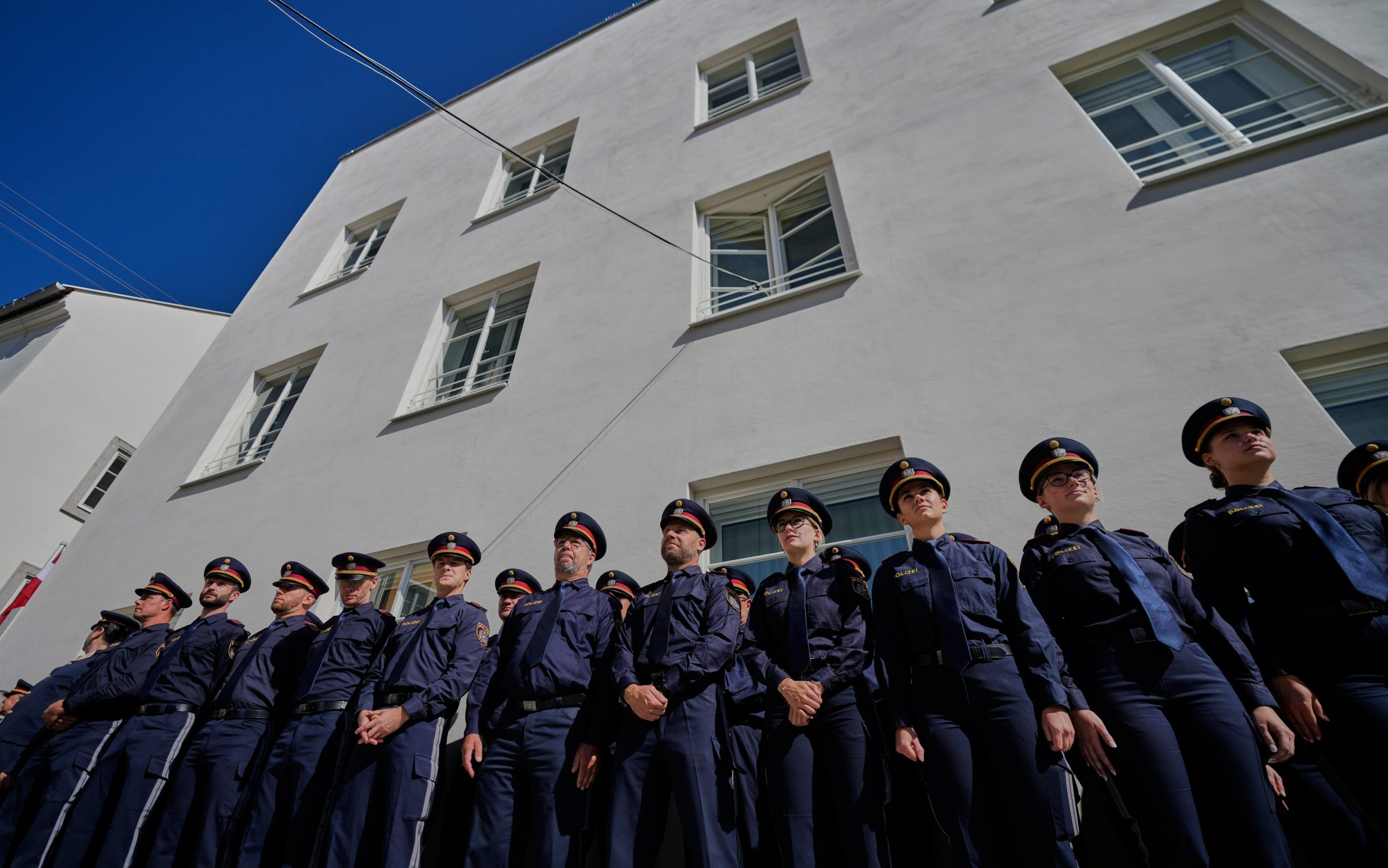 Austrian police officers stand in front of a the new police station located in Adolf Hitler's birth house in Braunau am Inn