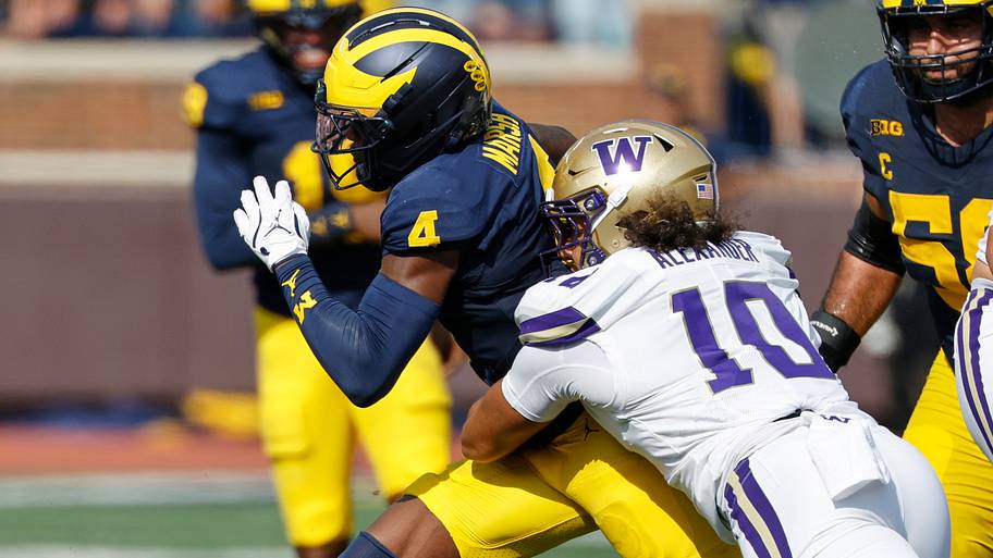 Michigan Wolverines wide receiver Andrew Marsh (4) is tackled by Washington Huskies