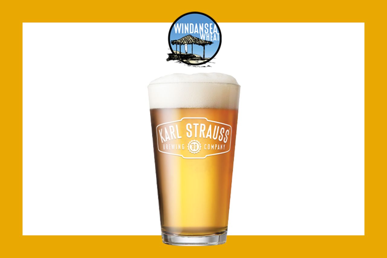 Karl Strauss branded wheat beer glass topped with foam Windansea Wheat logo above