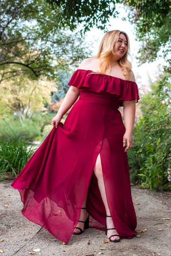 reviewer wearing burgundy dress