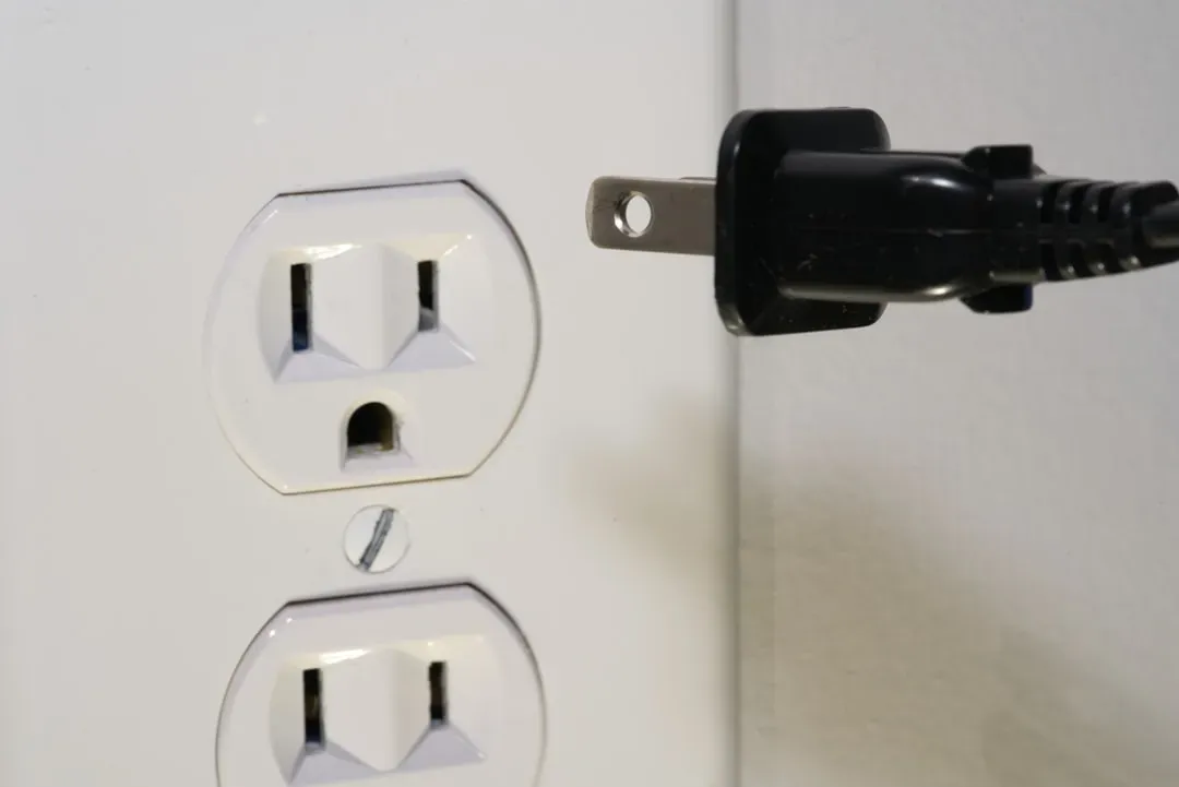 5. Outlets or switches that feel slightly warm (Image Credits: Unsplash)