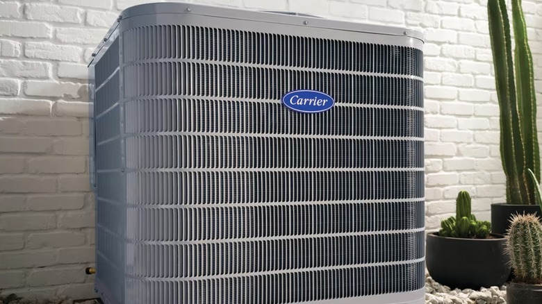 Who makes Carrier air conditioners, and what other brands do they own?