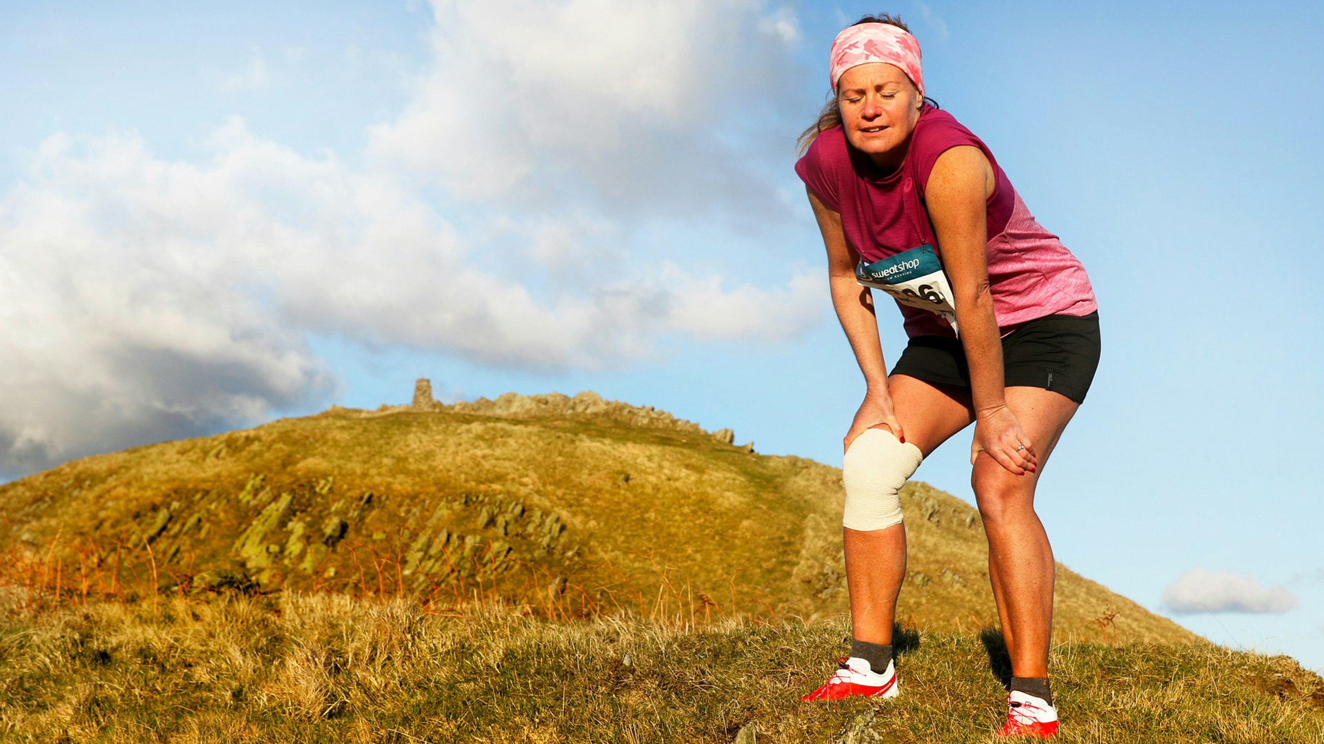 Fatigued trail runner on a hill during difficult trail race credit James Kirby