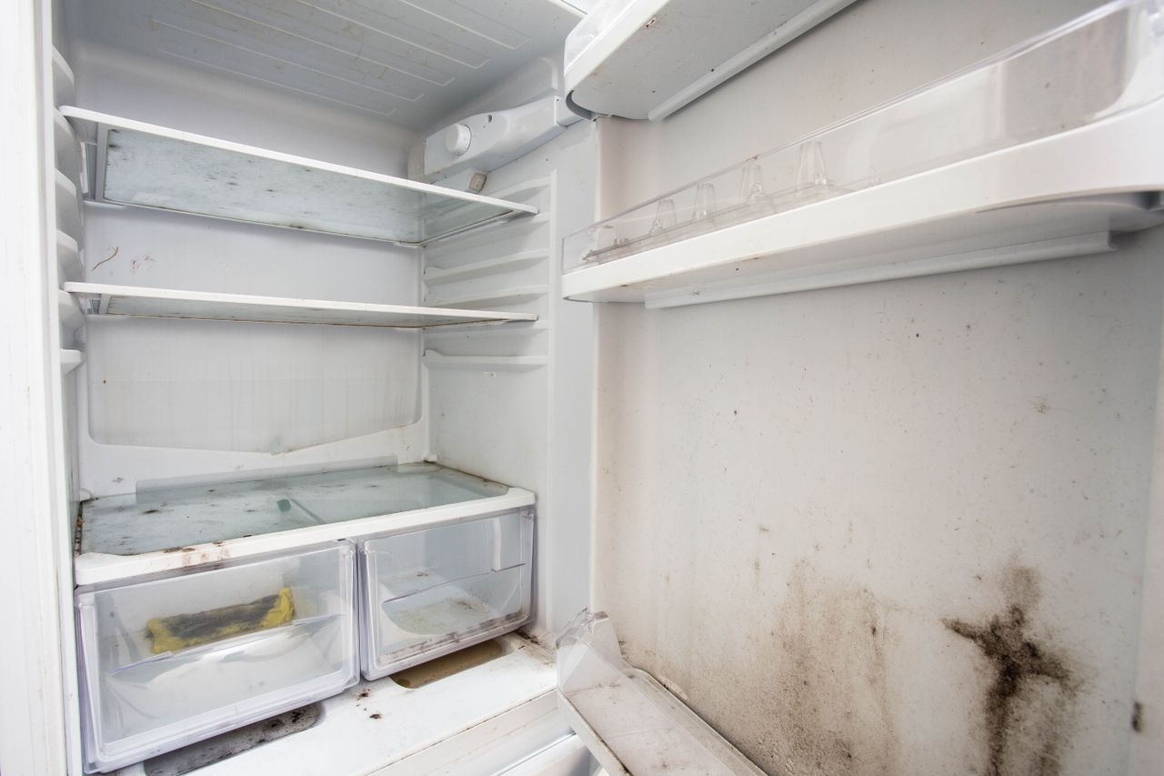 Old used dirty refrigerator with mold