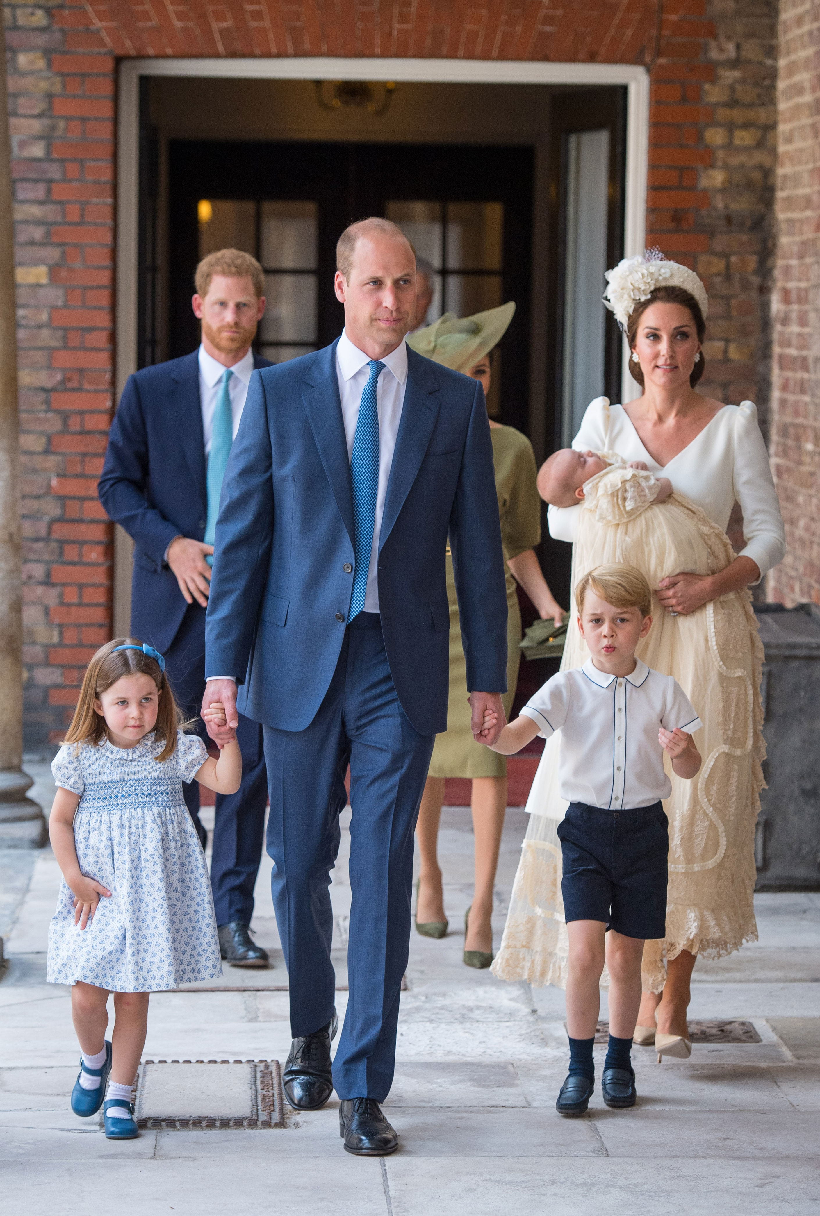 2018: Princess Charlotte and Prince George hold the hands of their father, Prince William, Duke of Cambridge, as they arrive at the Chapel Royal, St James's Palace, London for the christening of their brother, Prince Louis, who is being carried by their mother, Catherine, Duchess of Cambridge on July 9, 2018, in London, England.