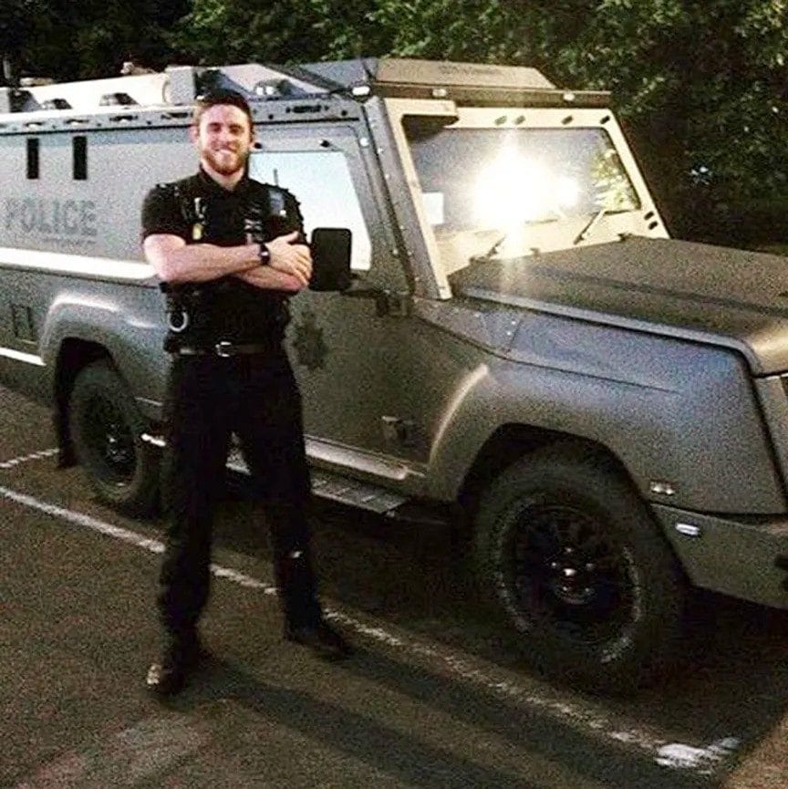 Pc Andrew Harper with a police vehicle