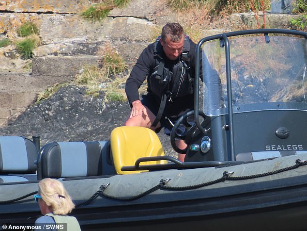 Bear, a former SAS trooper who became Chief Scout, donned a black T-shirt and blue shorts with a lifejacket as he disembarked his boat to greet the driver from the supermarket chain