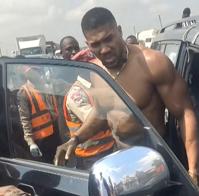 Joshua pictured moments after the tragic crash took place on a major road outside Lagos