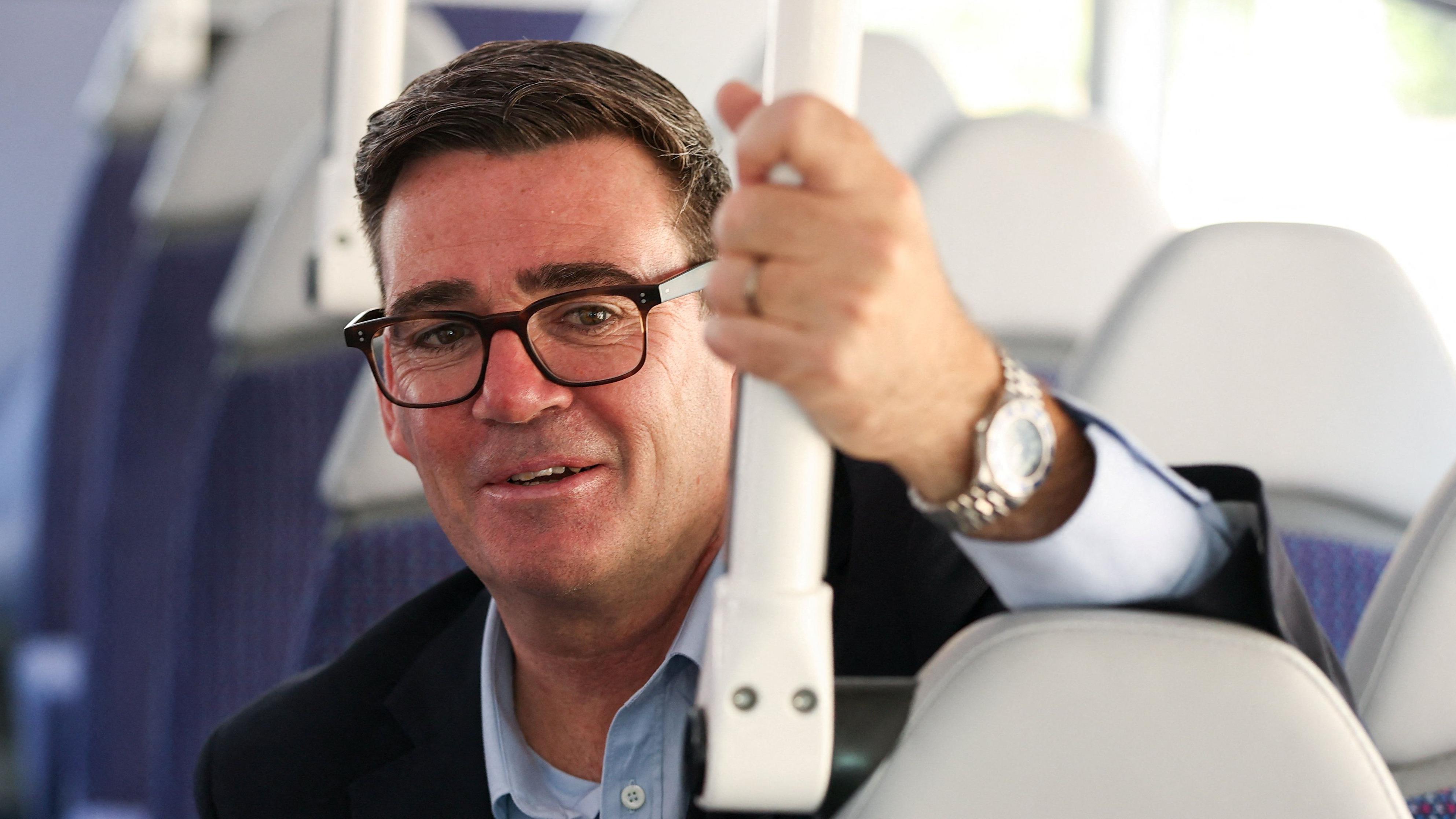 Prime Minister Andy Burnham aboard a bus as he announced the £2 fare cap