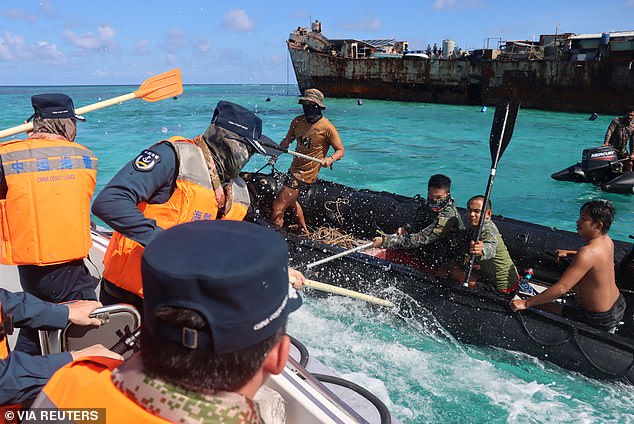 Members of the China Coast Guard and Armed Forces of the Philippines had a physical altercation (above) on Monday after the Chinese vessel allegedly entered Filipino waters