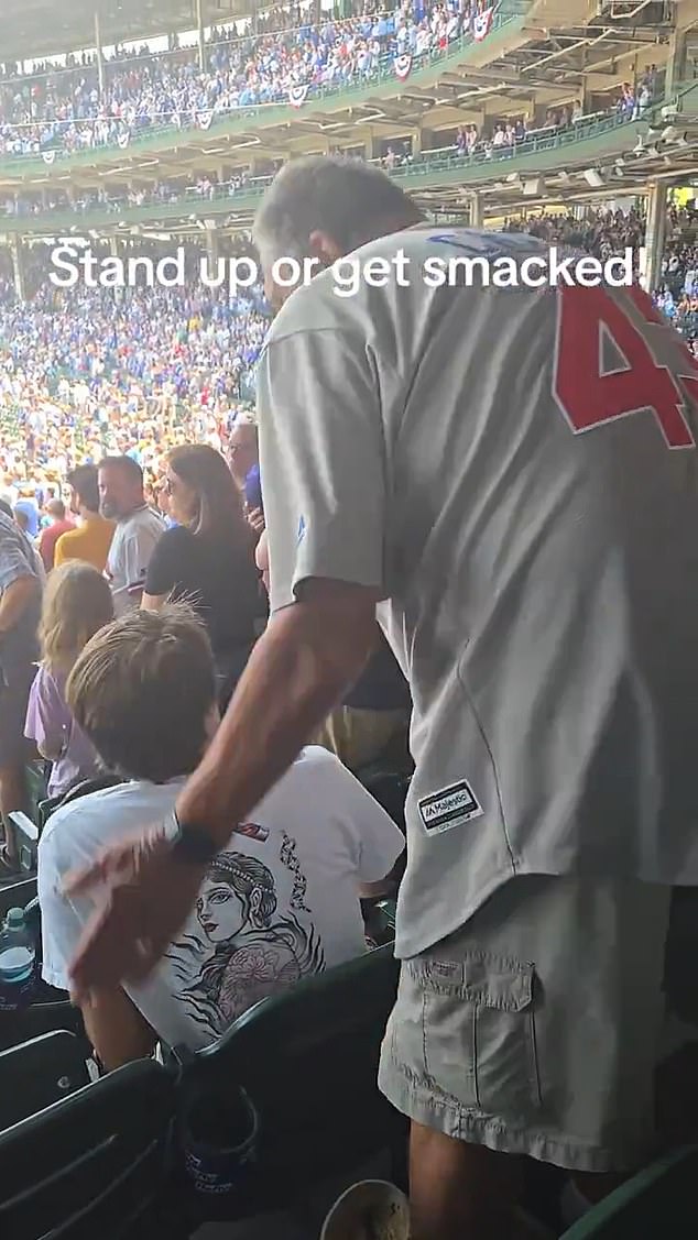A Chicago Cubs fan is speaking out after video captured him striking another fan in the back of the head for his refusal to stand for the national anthem before a game at Wrigley Field