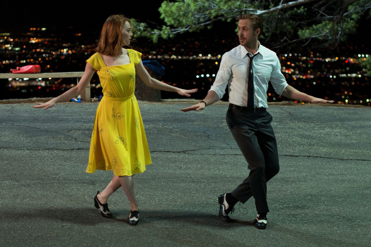 Ryan Gosling and Emma Stone performing a dance scene on a street