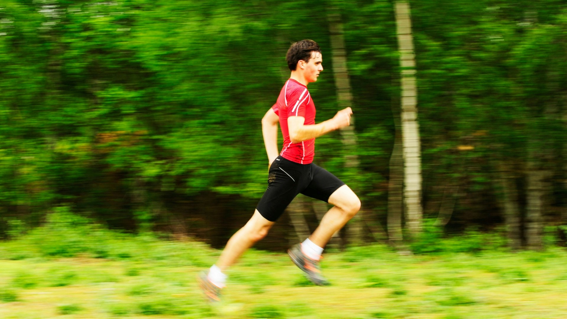 A man running past a woods