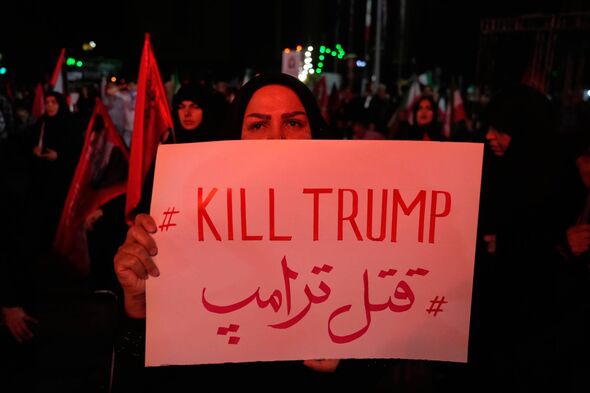 A pro-government demonstrator holds an anti-Trump placard in a gathering commemorating the late Iranian Supreme Leader Ayatollah Ali Khamenei at a square in Tehran, Saturday, July 11, 2026. (AP Photo/Vahid Salemi)