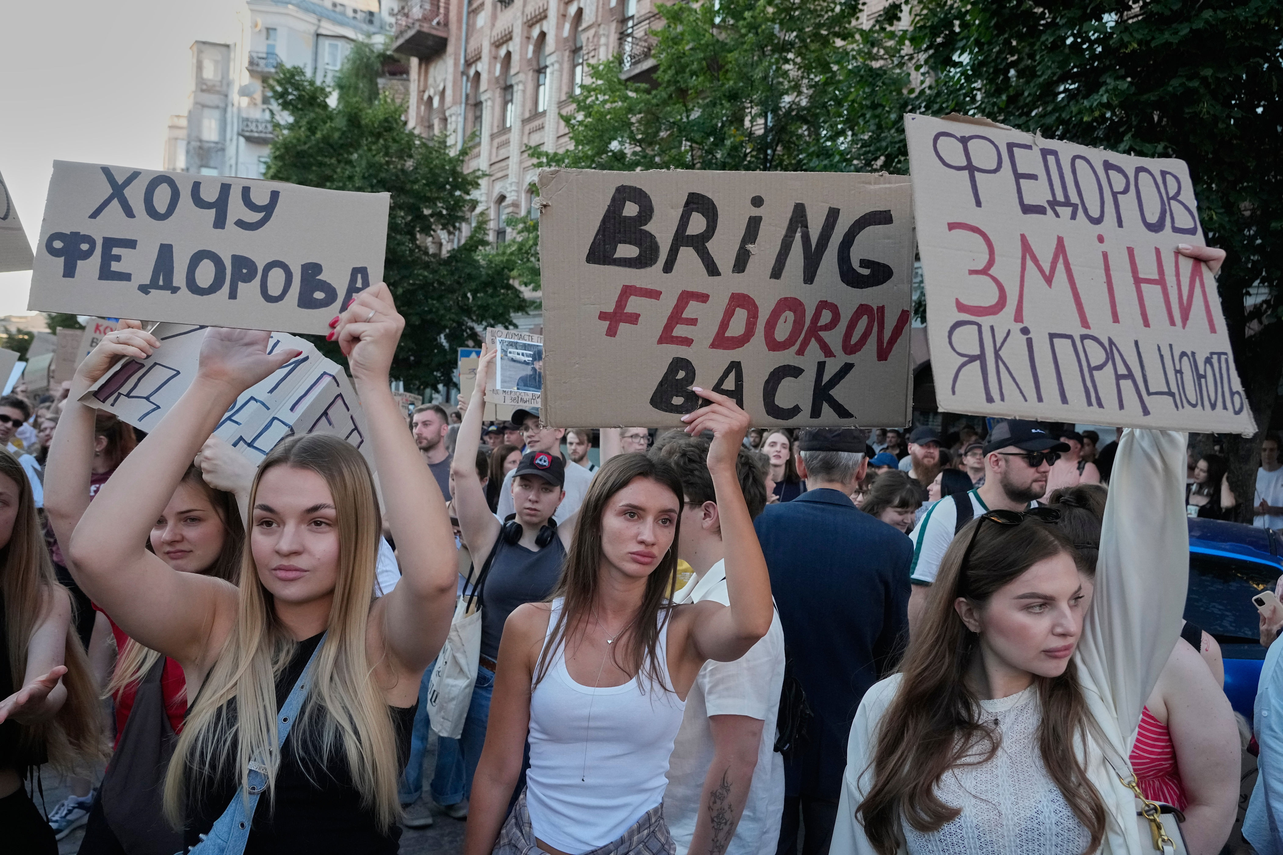 Activists shout slogans during a rally to denounce President Volodymyr Zelensky's decision to dismiss Defense Minister Mykhailo Fedorov after six months in the post, Friday, July 17 (AP)