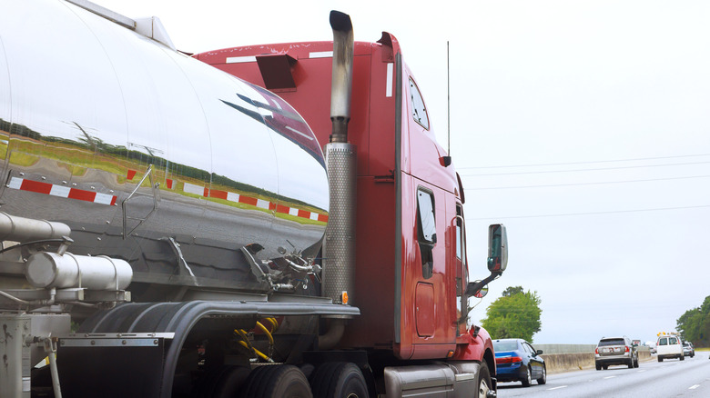Semi truck driving down highway, photographed from side