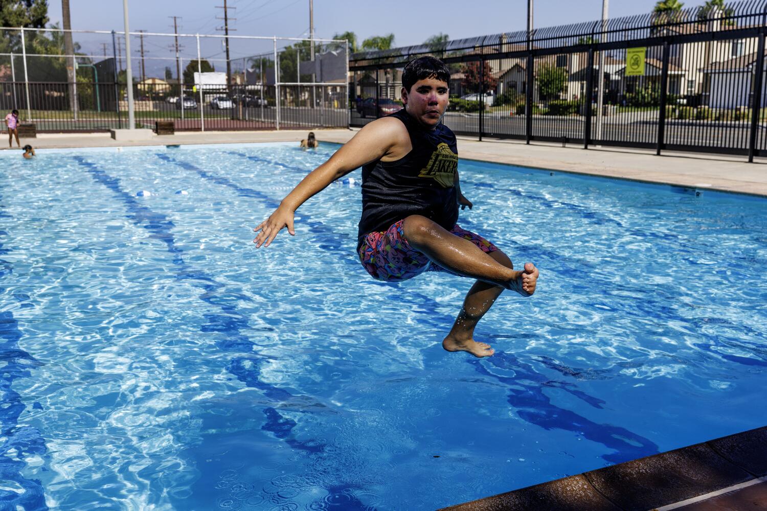 Nicholas Ibarra, 15, jumps into the city pool to cool off in the 108 degree temperatures in San Bernardino.