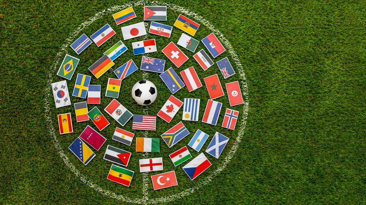 world-cup-concept-with-international-flags-circle-and-soccer-ball-on-grass-field