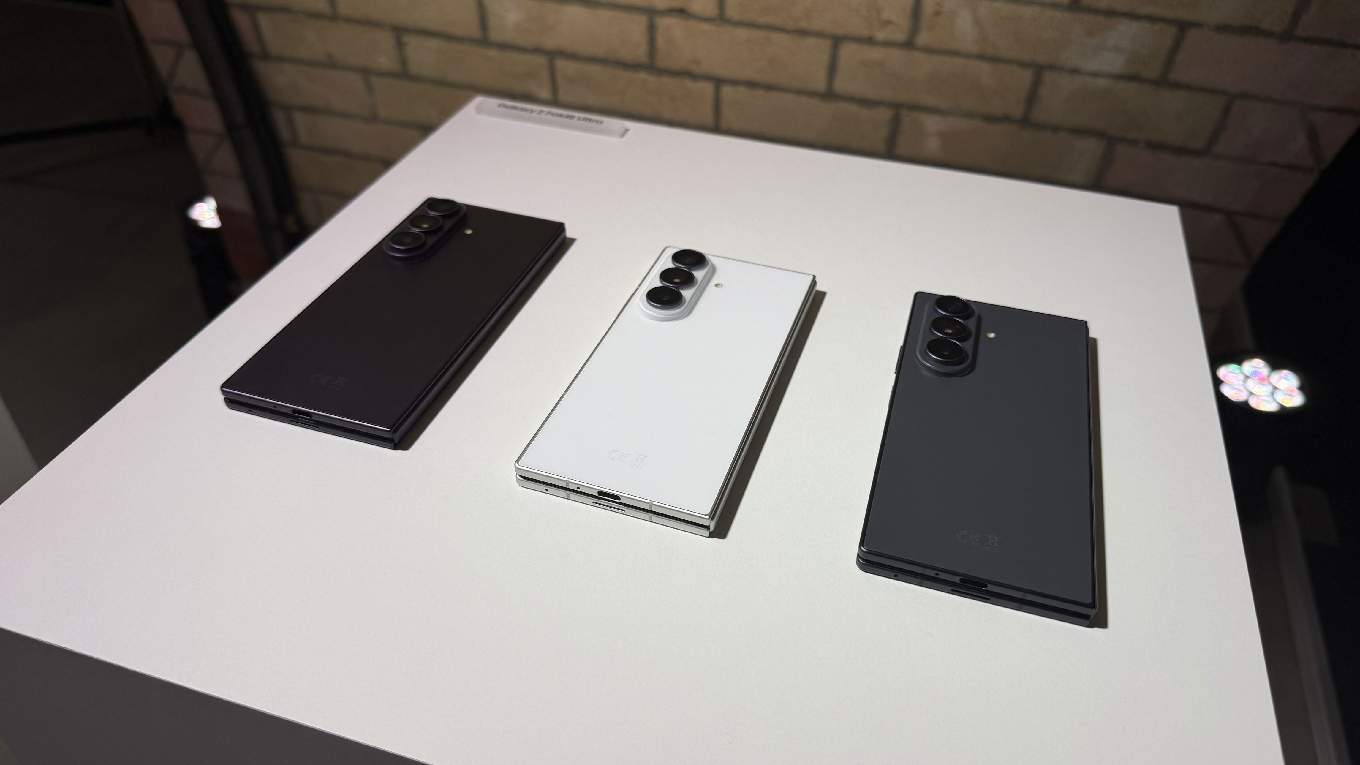Samsung Galaxy Z Fold 8 Ultra on a white tablet with a brick background