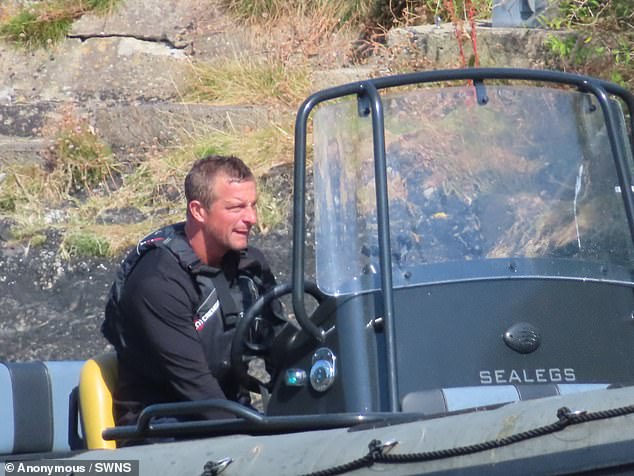 Bear's amphibious vehicle, which is capable of travelling on both land and water, parked on the sand
