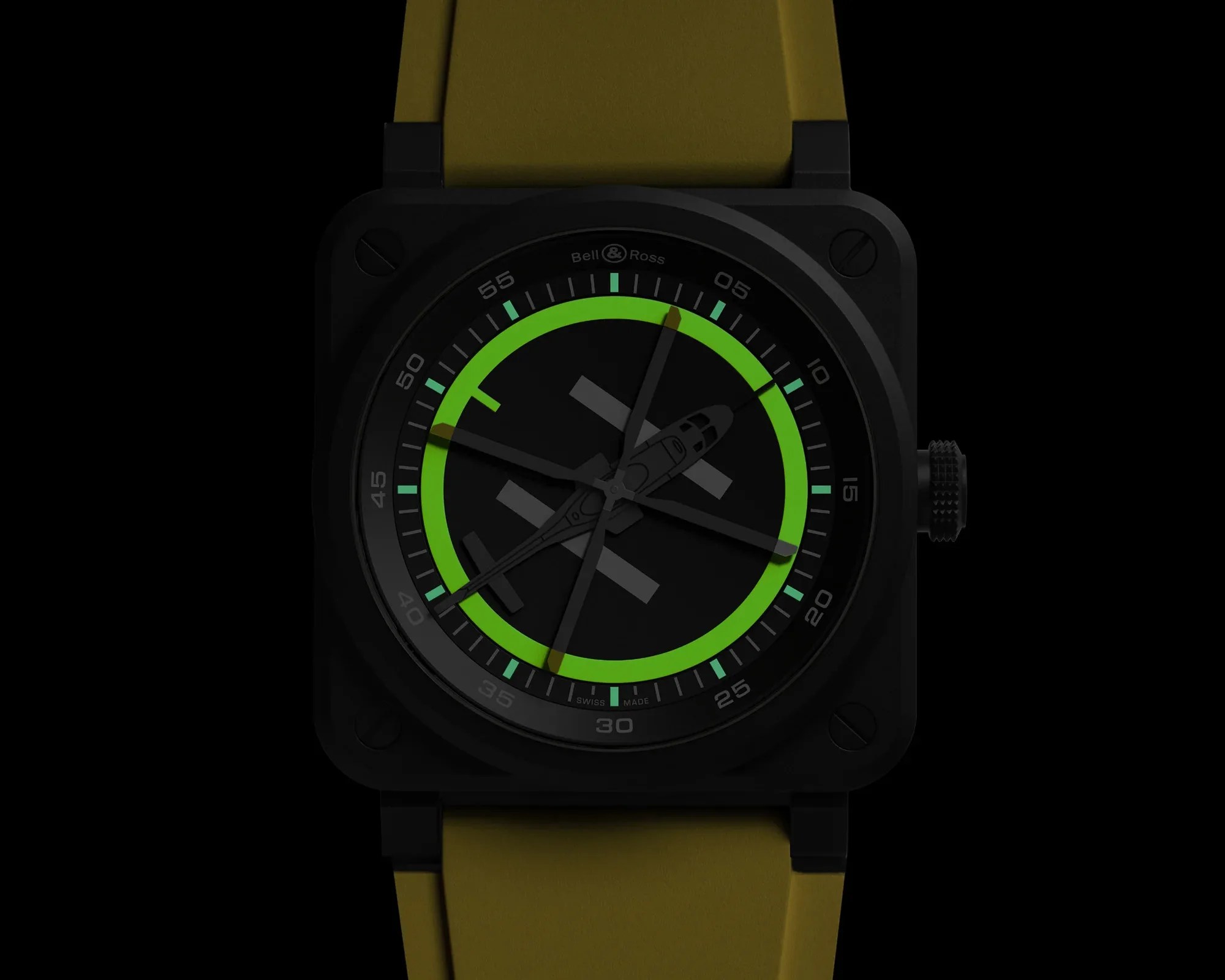 Square black Bell & Ross watch with green luminescent ring and yellow strap.