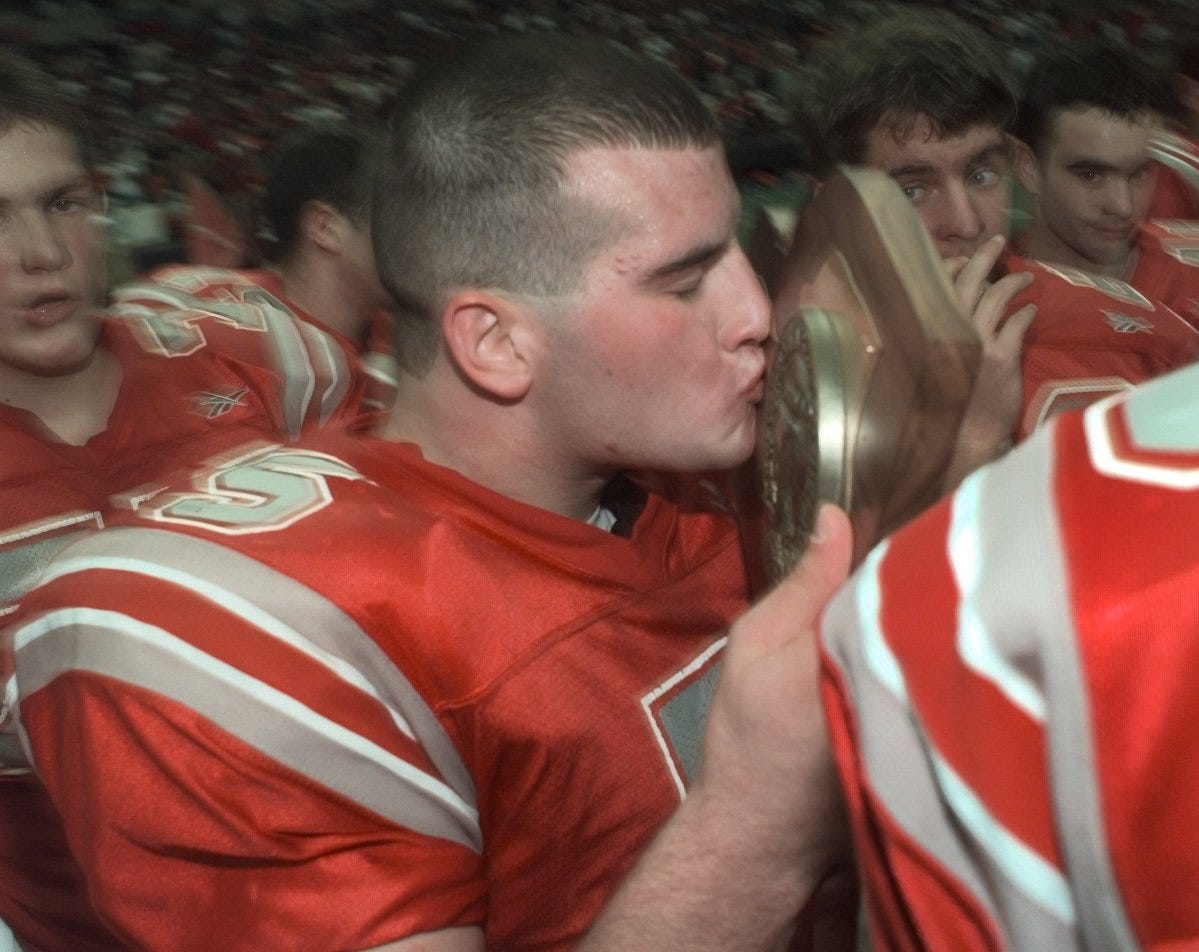 Canandaigua's Joe Davern kisses the state championship trophy after the Braves defeated Brewster Nov. 27, 1999 in Syracuse.