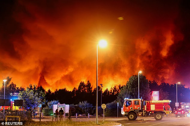Smoke and flames rise in Le Porge as a wildfire burn, as emergency servcies respond