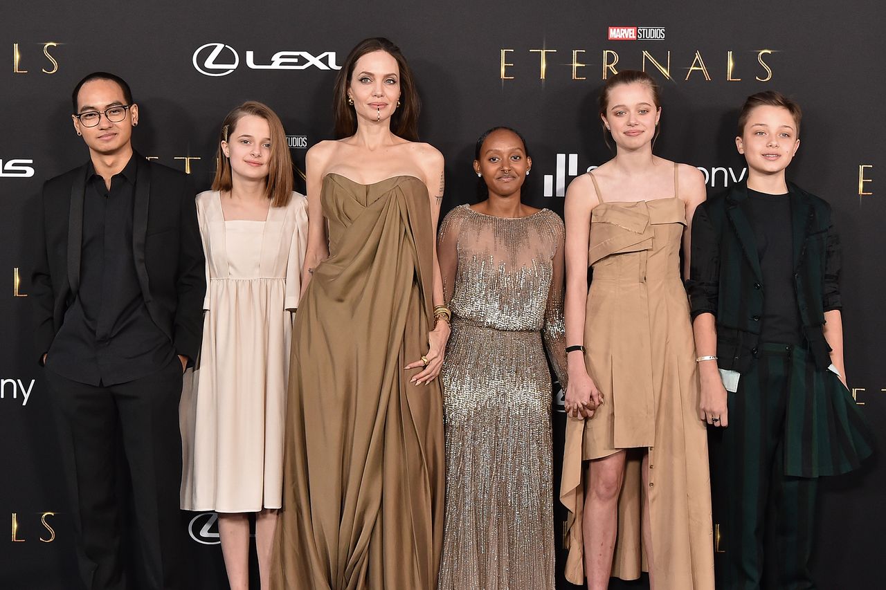 Angelina Jolie with her children posing on a movie premiere red carpet