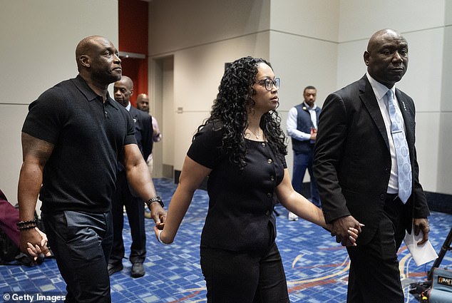 Elmore and Christine entered Wednesday's press conference hand-in-hand with Crump