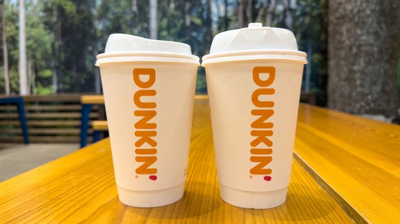 Two Dunkin' drinks on a table.