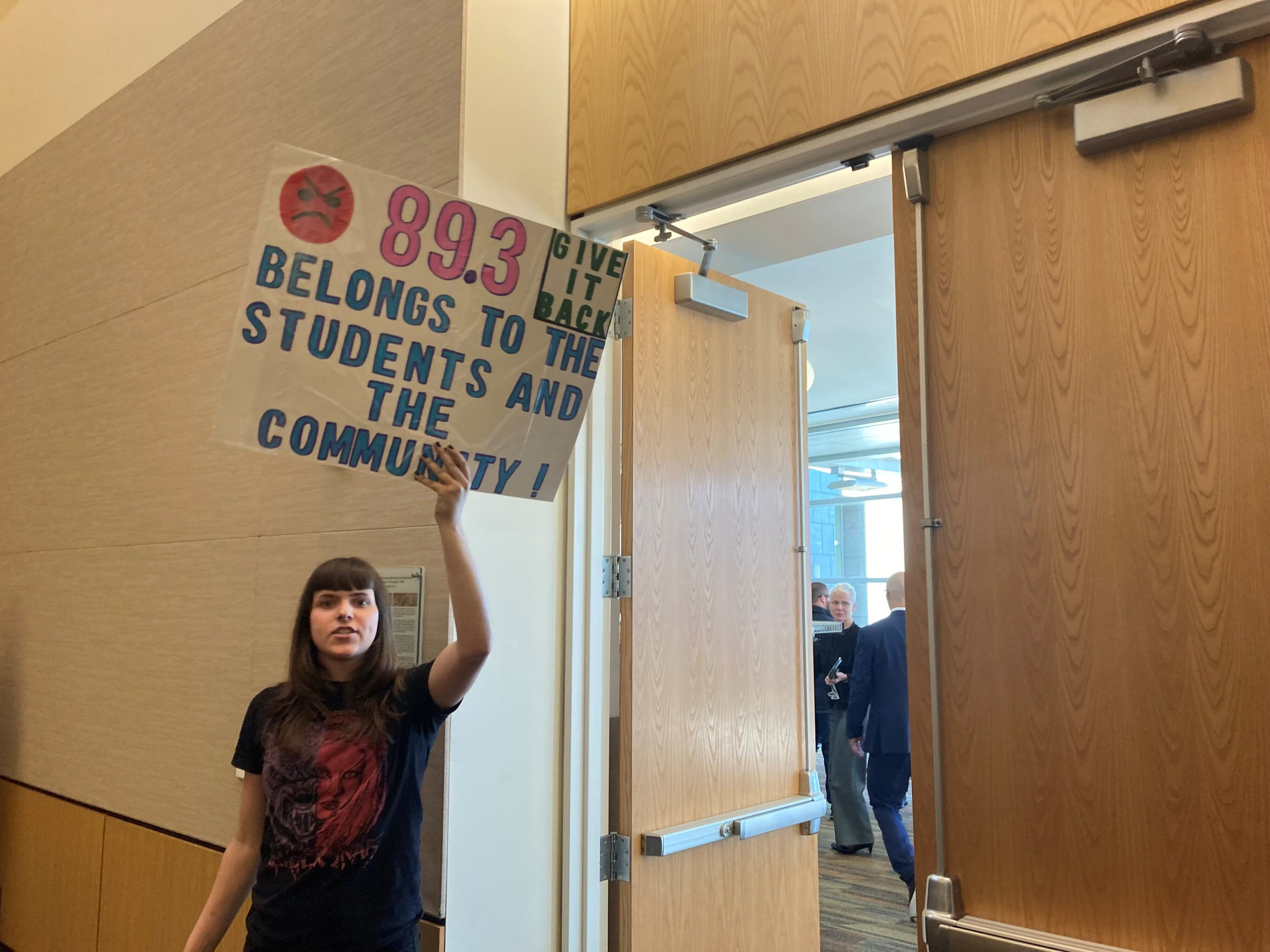 Jacklyn Bomgardner, a CSU student and former vice president at WCSB, holds a sign last year in protest of how the university gave control of the station to Ideastream. She's now head of a student organization hoping to take over where the WCSB student club left off.