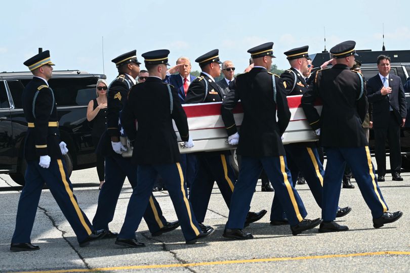 Trump salutes as a U.S. Army carry team carries the flag-draped transfer case