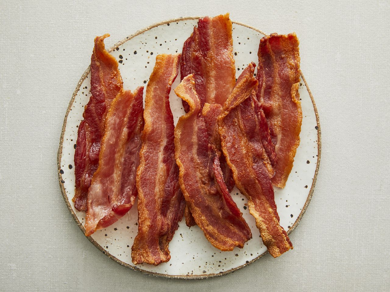 looking down at a plate full of crispy air fryer bacon