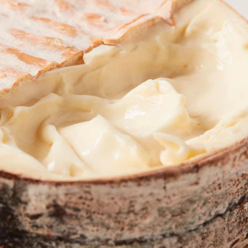 Winnimere cheese round cut open on top to show creaminess